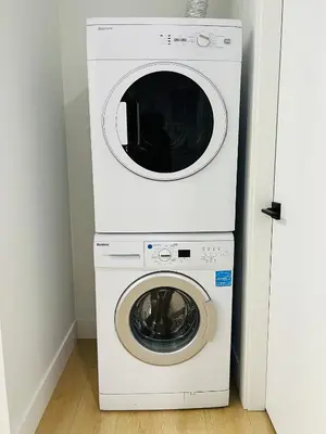 a white washer and dryer in a room at New and Modern 1 bedroom suite near beach in Surrey