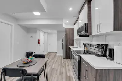 a kitchen with a table and chairs in a room at TheCozyNest in Calgary