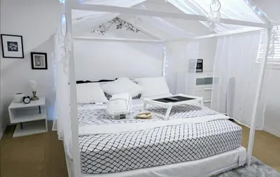 a white bedroom with a bed with a canopy at Charming Beautiful Private Room With Private Bath and Parking! Near Metrotown in Burnaby