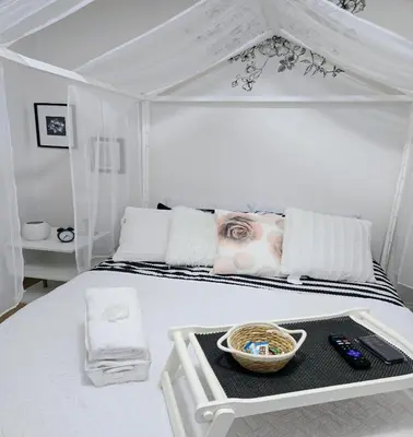 a white bedroom with a white bed with a basket on it at Charming Beautiful Private Room With Private Bath and Parking! Near Metrotown in Burnaby
