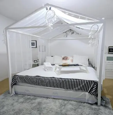 a white bed with a canopy in a bedroom at Charming Beautiful Private Room With Private Bath and Parking! Near Metrotown in Burnaby