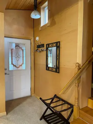 a hallway with a white door and a mirror at Luna Bed & Breakfast in Grand Forks