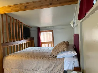 a bedroom with a bed and a television and a window at Luna Bed & Breakfast in Grand Forks
