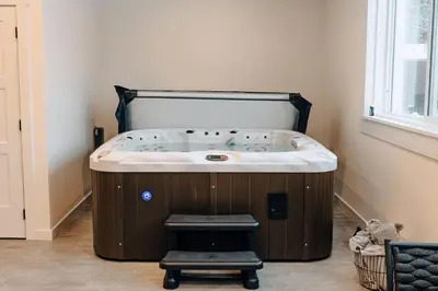 a jacuzzi tub in the corner of a room at Revy To Go - Unique 2-Bedroom Condo in Revelstoke