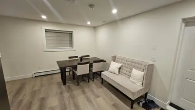 a dining room with a table and a couch at Your Home - Spacious Private Suite in Delta