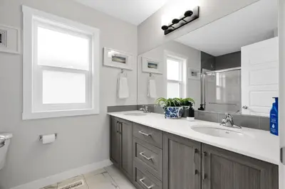 a bathroom with a sink and a window at Spacious 3-Bedroom Vacation Home in Calgary with Free Parking in Calgary