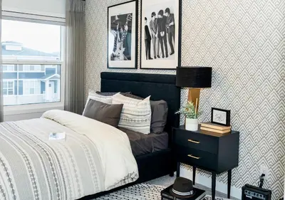 a bedroom with a bed and a table with a lamp at Strawberry Fields 4BD Family Movie Room Office in Calgary