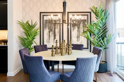 a dining room with a table and blue chairs at Strawberry Fields 4BD Family Movie Room Office in Calgary
