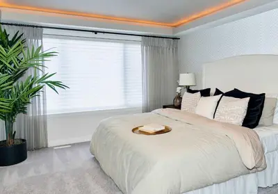 a bedroom with a large bed with a large window at Strawberry Fields 4BD Family Movie Room Office in Calgary