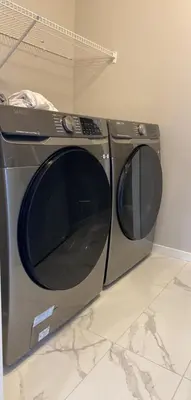 a washing machine sitting on top of a counter at Cozy House In Airdrie in Airdrie