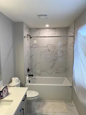 a bathroom with a tub and a toilet and a sink at Cozy House In Airdrie in Airdrie
