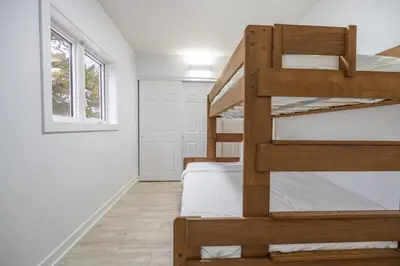a bedroom with two bunk beds and a window at The Pines on 15th Ave - Hot Tub, BBQ in Invermere