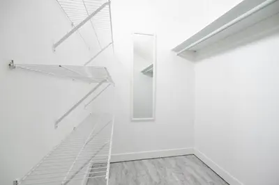 a white room with a glass shelf and a mirror at The Pines on 15th Ave - Hot Tub, BBQ in Invermere