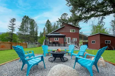 a group of blue chairs sitting around a fire pit at The Pines on 15th Ave - Hot Tub, BBQ in Invermere