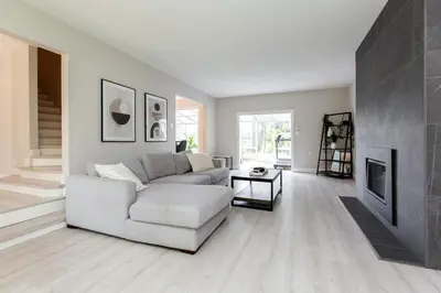 a living room with a white couch and a fireplace at Modern 5BR Luxury Getaway in Cobble Hill