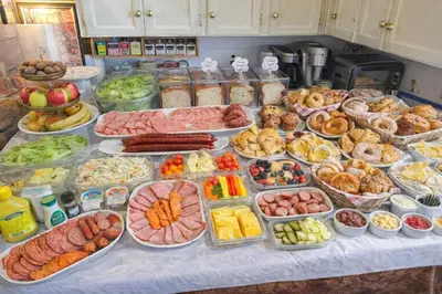 a table filled with lots of different types of food at Cozy Nook in Fraser Valley Getaway with Breakfast in Abbotsford