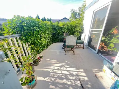a patio with a table and chairs and plants at Cozy Nook in Fraser Valley Getaway with Breakfast in Abbotsford