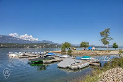 a group of boats are docked in the water at Akiskinook Resort by StayIn in Windermere