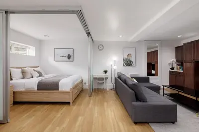 a bedroom with a bed and a couch at Cozy 1BR BSMT Escape Large Free Parking in Coquitlam