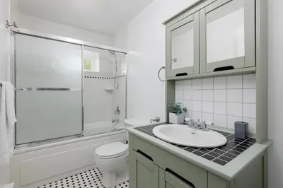 a bathroom with a sink and a toilet and a shower at Cozy 1BR BSMT Escape Large Free Parking in Coquitlam
