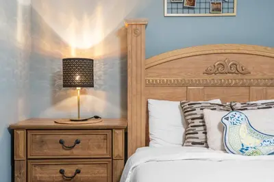 a bedroom with a bed and a lamp on a nightstand at Private Family Entertainer's Suite in Calgary