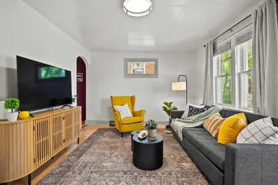 a living room with a couch and a tv at The Canary 2BR Gem in Downtown Drumheller in Drumheller