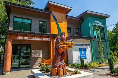 a wooden statue in front of a building at The Riverbend Modern Studio at Harrison Lake in Harrison Hot Springs