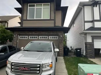 a white truck parked in front of a house at The Flight Line in Calgary