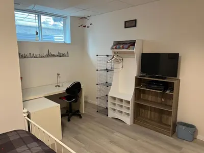a room with a desk with a tv and a desk sidx sidx sidx at The Flight Line in Calgary