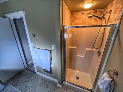 a bathroom with a shower with a glass door at Sunny Shuswap B&B in Chase