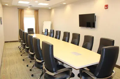 a conference room with a long table and chairs at Holiday Inn Express & Suites Cold Lake by IHG in Cold Lake
