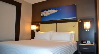 a hotel room with a bed with a jet on the wall at Holiday Inn Express & Suites Cold Lake by IHG in Cold Lake