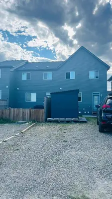 a large blue house with a car parked in front of it at Calgary Airport Getaway Spacious 3BR Full Home in Calgary