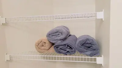 four towels on a shelf in a closet at Calgary Airport Getaway Spacious 3BR Full Home in Calgary