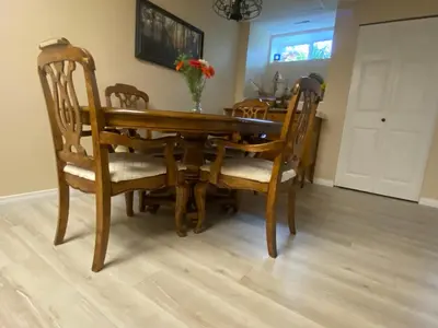 a dining room table and chairs with a vase on it at Remo Ridge Bed N Breakfast in Terrace