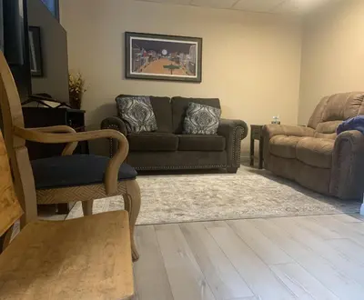 a living room with a couch and a chair at Remo Ridge Bed N Breakfast in Terrace