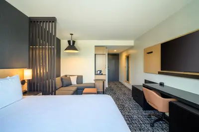 a hotel room with a bed and a flat screen tv at Hyatt Place Whitehorse in Whitehorse