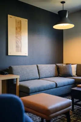 a living room with a blue couch in a room at Hyatt Place Whitehorse in Whitehorse