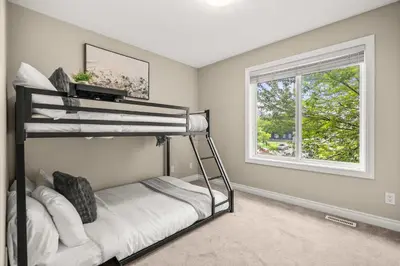 a bedroom with a bunk bed and a window at Social Haus Trendy 3BR Townhome in Bridgeland YYC in Calgary