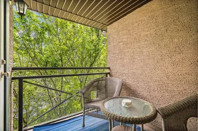 a patio with a table and chairs on a balcony at Social Haus Trendy 3BR Townhome in Bridgeland YYC in Calgary