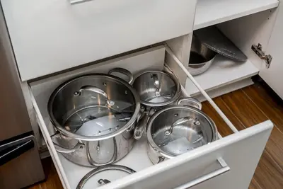 a bunch of silver pots and pans in a drawer at Spacious Downtown Condo with Pool Gym & Parking in Vancouver
