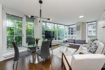 a living room with a couch and a table at Spacious Downtown Condo with Pool Gym & Parking in Vancouver