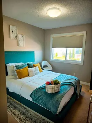 a bedroom with a bed with a bowl of fruit on it at Stonecroft House in Calgary
