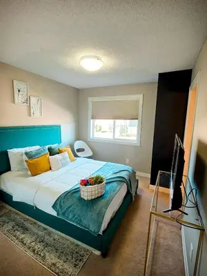 a bedroom with a bed with a basket of flowers on it at Stonecroft House in Calgary