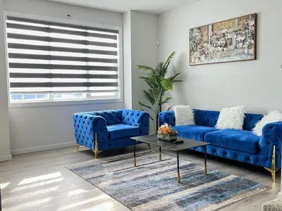 a living room with blue couches and a table at single house in Edmonton