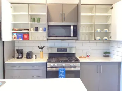 a kitchen with a stove and a microwave at single house in Edmonton