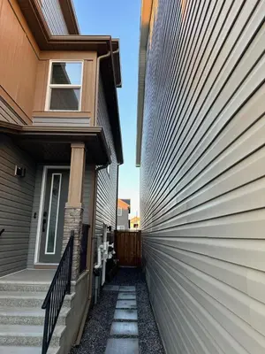 a metal fence on the side of a house at The Seton Nook - 1BR Suite Near Seton Health Campus, Cineplex and YMCA in Calgary
