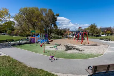 a park with a playground with a slide at Garden Cottage and Bunkie at Horner Park in Victoria