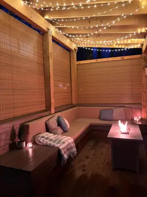 a room with a bench in a room with lights at Riverwood Retreat-hot tub and cedar sauna on the river in Squamish