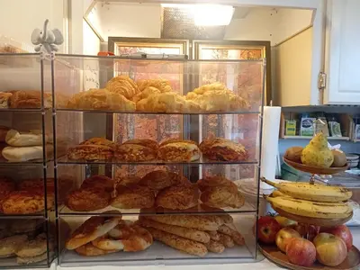 a display case filled with different types of pastries at Comfy Sleep In Fraser Valley With Breakfast in Abbotsford